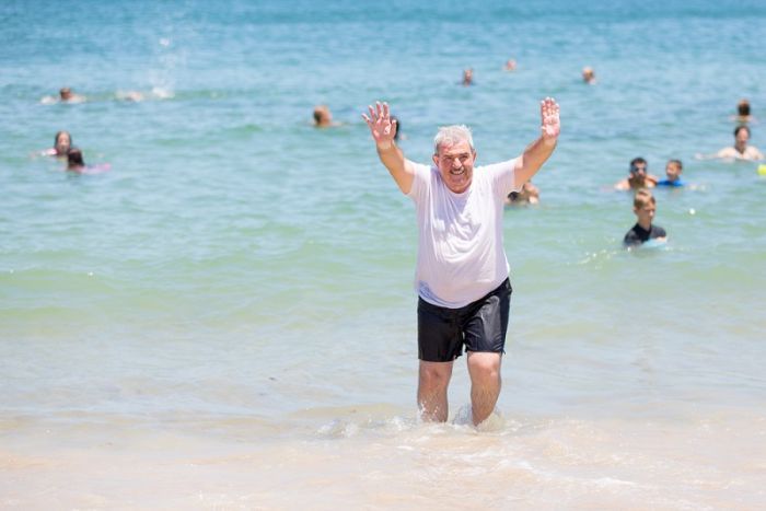 Syrian, Iraqi refugees dive into first Queensland summer with beach swim